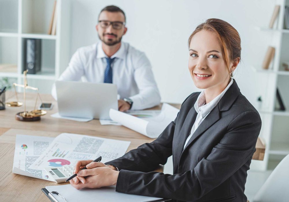 smiling-financiers-looking-at-camera-in-office-2023-11-27-05-34-53-utc.jpg